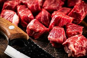 Raw beef sliced on a dark background. photo