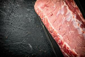 Raw pork on a cutting board. photo