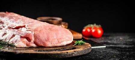 Raw pork with rosemary and tomatoes. photo