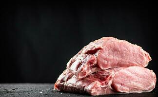 Pieces of raw pork on the table. photo