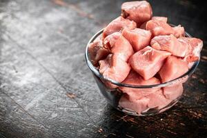 Raw pork sliced in a glass bowl. photo