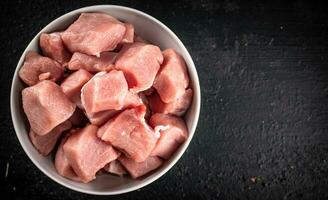 Chopped raw pork in a bowl. photo