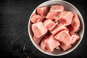 Chopped raw pork in a bowl. photo