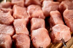 Pork raw kebab on a cutting board. photo