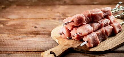 Pork kebab raw on a cutting board. photo