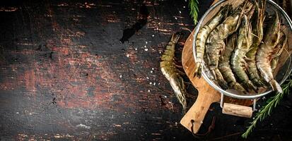 Fresh uncooked shrimp in a colander. photo