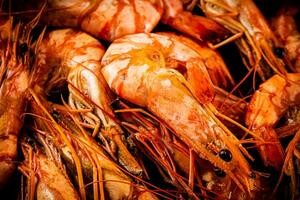 Red shrimp are boiled in water. Macro background. photo