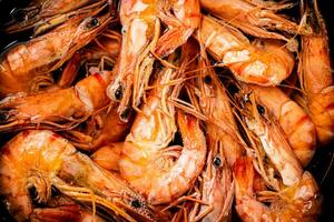 Red shrimp are boiled in water. Macro background. photo