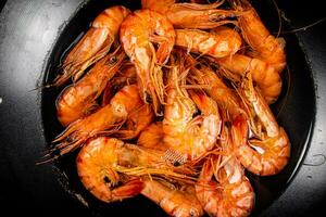 Saucepan with cooked boiled shrimp. photo