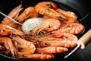 The shrimp are cooked in a pot of water. photo