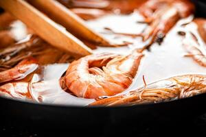 The shrimp are cooked in a pot of water. photo