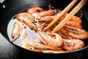 The shrimp are boiled in a pot of water. photo