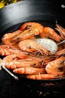 The shrimp are boiled in a pot of water. photo