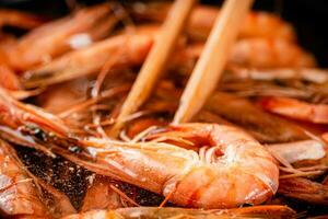 The shrimp are cooked in a pot of water. photo