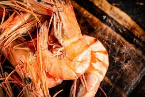 Cooked shrimp on a wooden cutting board. photo