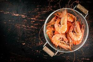 Fragrant boiled shrimp in a colander. photo