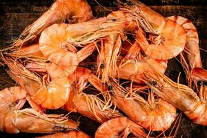 Cooked shrimp on a wooden cutting board. photo