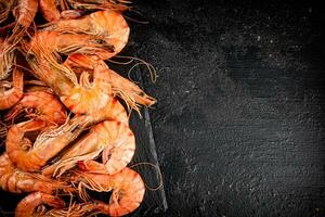 Delicious boiled shrimp on a stone board. photo