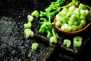 Fresh celery slices on a cutting board. photo