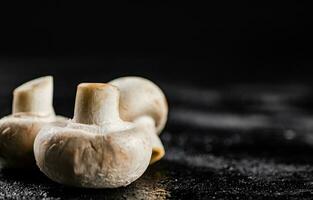 Fresh mushrooms champignons on the table. photo