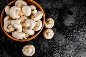 Fresh mushrooms in a wooden plate. photo