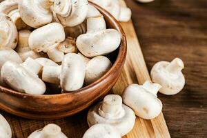 Mushrooms in a bowl on a cutting board. photo