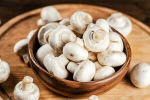 Mushrooms in a bowl on a cutting board. photo