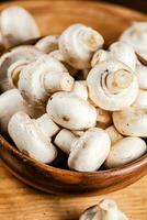 Fresh mushrooms in a wooden bowl. photo