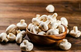 A wooden plate full of fresh mushrooms. photo