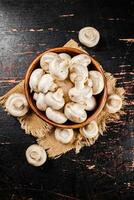 Mushrooms in a wooden plate on a napkin. photo