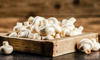 Fresh mushrooms on a wooden tray. photo