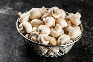 Fresh mushrooms in a colander. photo