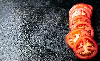 Sliced fresh tomatoes. On a black background. photo