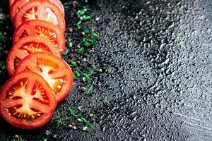 Sliced fresh tomatoes. On a black background. photo