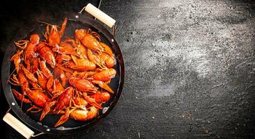 Boiled crayfish in a pot of water. photo