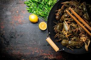 Fresh uncooking crayfish in a pot of lemon and parsley. photo