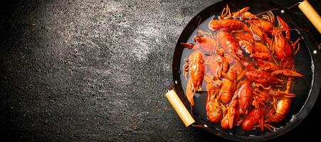 Boiled crayfish in a pot of water. photo