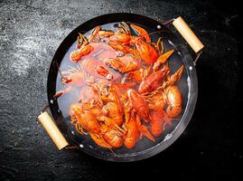 Boiled crayfish in a pot of water. photo