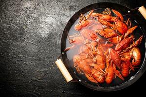 Boiled crayfish in a pot of water. photo