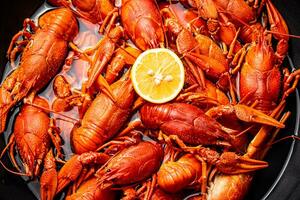 Crayfish are boiled in a pot in water. photo