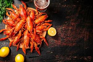 Boiled crayfish with a glass of beer and lemon. photo