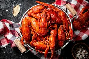 Boiled crayfish in a colander on a napkin. photo