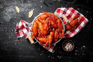Boiled crayfish in a colander on a napkin. photo