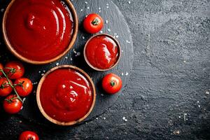 Tomato sauce in a wooden plate. photo