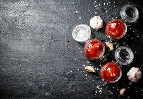 Jars of tomato sauce with garlic and salt. photo