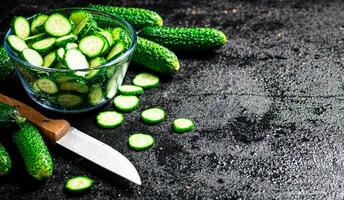 Full glass bowl of chopped fresh cucumbers. photo