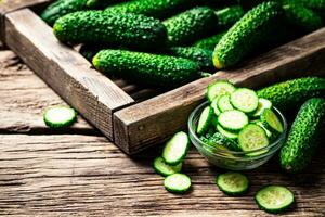 Sliced fresh cucumbers in a glass bowl. photo