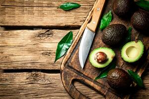 Halves of fresh avocado on a cutting board. photo