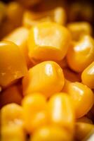 Grains of canned corn. Macro background. photo