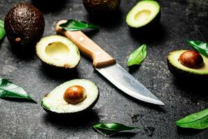 Pieces of fresh avocado with leaves. photo
